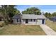 Charming single story home featuring a concrete driveway, tidy landscaping, and a neutral paint scheme at 1066 Swanson Dr, Deltona, FL 32738