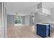 Open living space with light wood floors, modern lighting, and easy access to the kitchen at 1066 Swanson Dr, Deltona, FL 32738