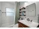 Updated bathroom with white subway tile, wooden shelves, and modern fixtures at 116 E Lauren Ct, Fern Park, FL 32730