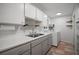 Bright laundry room featuring white cabinets, countertops, and a modern washer and dryer at 116 E Lauren Ct, Fern Park, FL 32730