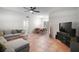 Open-concept living room and dining area with terra cotta tile flooring and contemporary furnishings at 116 E Lauren Ct, Fern Park, FL 32730