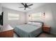 Cozy main bedroom featuring dual windows, ceiling fan, and decorative wall lighting at 116 E Lauren Ct, Fern Park, FL 32730