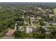 Aerial view of a charming home nestled in a leafy neighborhood with mature trees and well-maintained properties at 1161 Roxboro Rd, Longwood, FL 32750