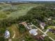 Aerial view of a neighborhood home near a lush, natural wetland area, offering a serene backdrop at 1161 Roxboro Rd, Longwood, FL 32750