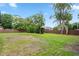 Overhead view of spacious backyard with privacy fence, mature trees and green lawn at 1161 Roxboro Rd, Longwood, FL 32750