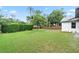 Expansive backyard with lush green lawn, mature trees, and privacy fence at 1161 Roxboro Rd, Longwood, FL 32750