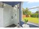 Well-lit bathroom showcasing a modern glass shower and a window with a lovely green view at 1161 Roxboro Rd, Longwood, FL 32750