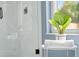 Stylish bathroom featuring a glass shower, a view to the outdoors, and tasteful decor at 1161 Roxboro Rd, Longwood, FL 32750
