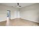 Large empty bedroom with new wood floors, neutral walls, ceiling fan, and closet at 1161 Roxboro Rd, Longwood, FL 32750