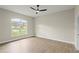 Spacious bedroom with new wood floors, large window, and modern ceiling fan at 1161 Roxboro Rd, Longwood, FL 32750
