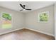 Inviting bedroom with new floors, two large windows allowing natural light and outdoor views at 1161 Roxboro Rd, Longwood, FL 32750