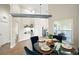 Bright dining area with a glass-top table and seating, offering views into a sunroom and open kitchen area at 1161 Roxboro Rd, Longwood, FL 32750