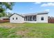 Rear exterior of home showcasing screened patio, manicured lawn and updated features at 1161 Roxboro Rd, Longwood, FL 32750