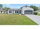 Charming single-story home with a manicured lawn, neutral tones, and attached two-car garage at 1161 Roxboro Rd, Longwood, FL 32750