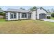 Single-story home with a well-manicured lawn, gray roof, and an attached garage in a suburban setting at 1161 Roxboro Rd, Longwood, FL 32750