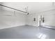 Spacious two-car garage with epoxy flooring and ample storage space at 1161 Roxboro Rd, Longwood, FL 32750