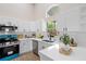 Charming kitchen featuring white cabinets, stainless steel appliances, and a bright teal stove and oven at 1161 Roxboro Rd, Longwood, FL 32750