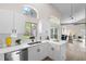 Bright, open kitchen with stainless steel appliances, white cabinets, and a view into adjacent living areas at 1161 Roxboro Rd, Longwood, FL 32750