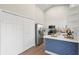 Bright kitchen showcases white cabinetry, stainless steel appliances, and a stylish blue paneled island for seating at 1161 Roxboro Rd, Longwood, FL 32750