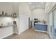 Modern kitchen with white cabinets, stainless steel appliances, a blue paneled island, and convenient coffee bar at 1161 Roxboro Rd, Longwood, FL 32750