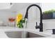 Close up of a kitchen sink with a modern black faucet and white quartz countertop at 1161 Roxboro Rd, Longwood, FL 32750