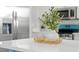 Bright kitchen featuring white countertops, stainless steel refrigerator, and stylish decorative plant centerpiece at 1161 Roxboro Rd, Longwood, FL 32750