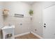 Functional laundry room features a utility sink, shelving, and ample space at 1161 Roxboro Rd, Longwood, FL 32750