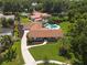 Aerial view of a home with a circular driveway, mature trees, and manicured lawn at 1191 Banbury Trl, Maitland, FL 32751