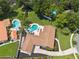 Aerial view of the property showing the pools, landscaping, neighboring homes and mature trees at 1191 Banbury Trl, Maitland, FL 32751