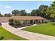 Beautiful single-story home with a manicured lawn, separate garage, mature trees, and a private backyard at 1191 Banbury Trl, Maitland, FL 32751