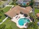 Stunning aerial view of a well-maintained home with a sparkling pool and lush landscaping at 1191 Banbury Trl, Maitland, FL 32751