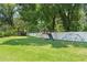 Backyard featuring green grass, a playset, privacy fence, and shade trees at 1191 Banbury Trl, Maitland, FL 32751