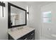 Chic bathroom with a marble countertop, dark vanity, and modern lighting fixtures at 1191 Banbury Trl, Maitland, FL 32751