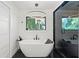 Stylish bathroom with a freestanding tub, modern light fixture, and sleek black accents at 1191 Banbury Trl, Maitland, FL 32751