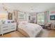 Cozy bedroom featuring rainbow decor, a ceiling fan, and warm natural light at 1191 Banbury Trl, Maitland, FL 32751