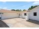 The exterior features a two car garage, a well manicured lawn, and white painted brick at 1191 Banbury Trl, Maitland, FL 32751
