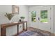 Inviting foyer with stylish console table, patterned rug, and bright entry door that allows for ample natural light at 1191 Banbury Trl, Maitland, FL 32751