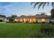 Charming single-story home featuring a lush front lawn, inviting porch with seating, and manicured landscaping at 1191 Banbury Trl, Maitland, FL 32751