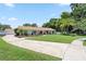 Single-story home featuring a lush front lawn, with palm trees and mature landscaping at 1191 Banbury Trl, Maitland, FL 32751