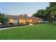 Charming single-story home featuring a lush front lawn, inviting porch with seating, and manicured landscaping at 1191 Banbury Trl, Maitland, FL 32751