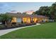 Charming single-story home with a well-manicured lawn and inviting front porch with colorful landscaping at 1191 Banbury Trl, Maitland, FL 32751