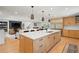 Bright open kitchen with a large island, counter seating, and stainless steel refrigerator at 1191 Banbury Trl, Maitland, FL 32751