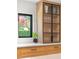 Kitchen detail with a cabinet with glass doors and a view of the outdoor landscape at 1191 Banbury Trl, Maitland, FL 32751