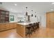Spacious kitchen featuring a large island with seating, modern appliances, and hardwood floors at 1191 Banbury Trl, Maitland, FL 32751