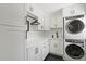 Well-organized laundry room with modern appliances, white cabinetry, and a sleek countertop at 1191 Banbury Trl, Maitland, FL 32751