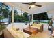 Relaxing covered outdoor patio featuring stylish wicker furniture and a refreshing pool in the backyard at 1191 Banbury Trl, Maitland, FL 32751