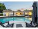 Backyard pool with chairs and a dining area for entertaining at 1191 Banbury Trl, Maitland, FL 32751