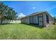 Large backyard features a well maintained lawn, a screened in patio, and a white fence at 12795 Bosworth Ave, Windermere, FL 34786