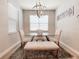 Formal dining room with chandelier, seating, and a large window at 12795 Bosworth Ave, Windermere, FL 34786