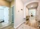 Hallway with light wood flooring leading to different rooms and a bathroom on the left at 12795 Bosworth Ave, Windermere, FL 34786